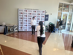 Chrisit Wade photographs Class of 2022 graduates in the Commencement Hot Spot Shot at the Marilyn Davies College of Business