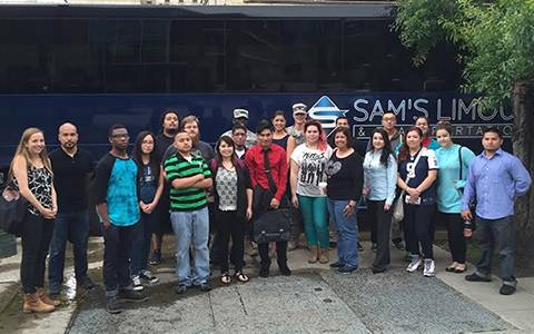 Group large of UHD Student by a charter bus