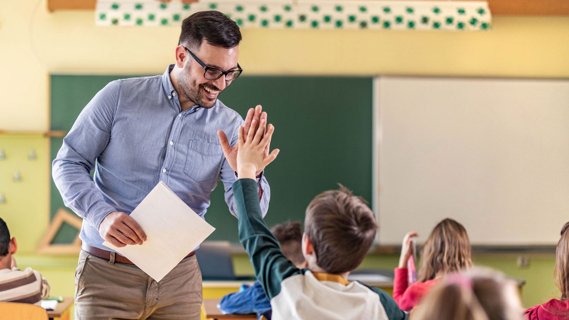 teacher high fiving student