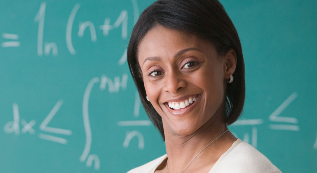 woman in front of a chalk board.