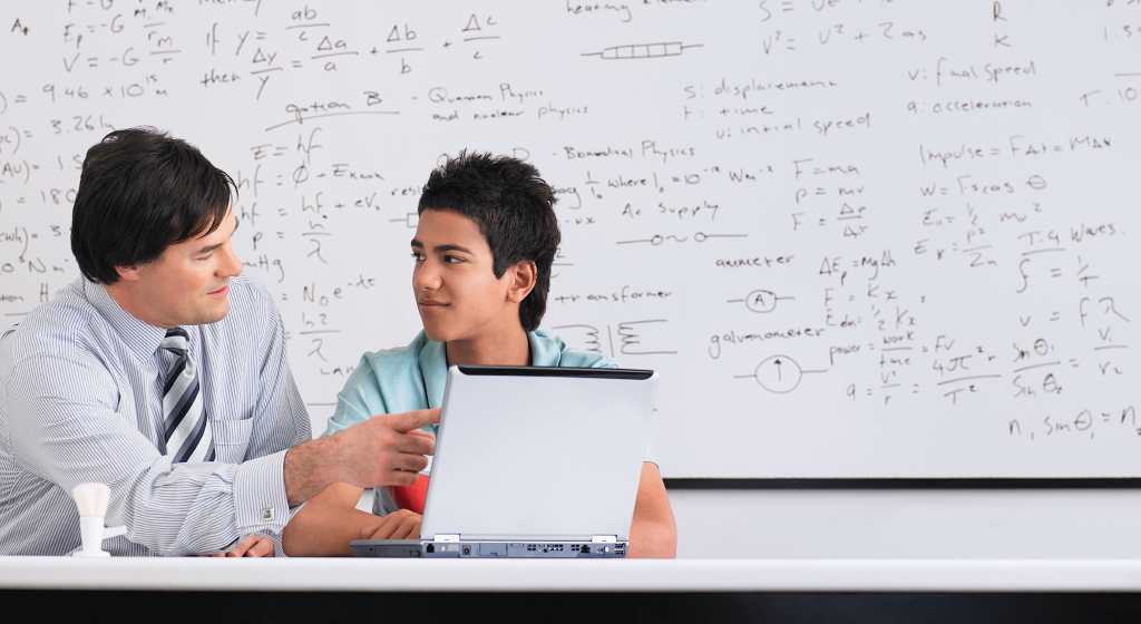 Teacher working with a student.