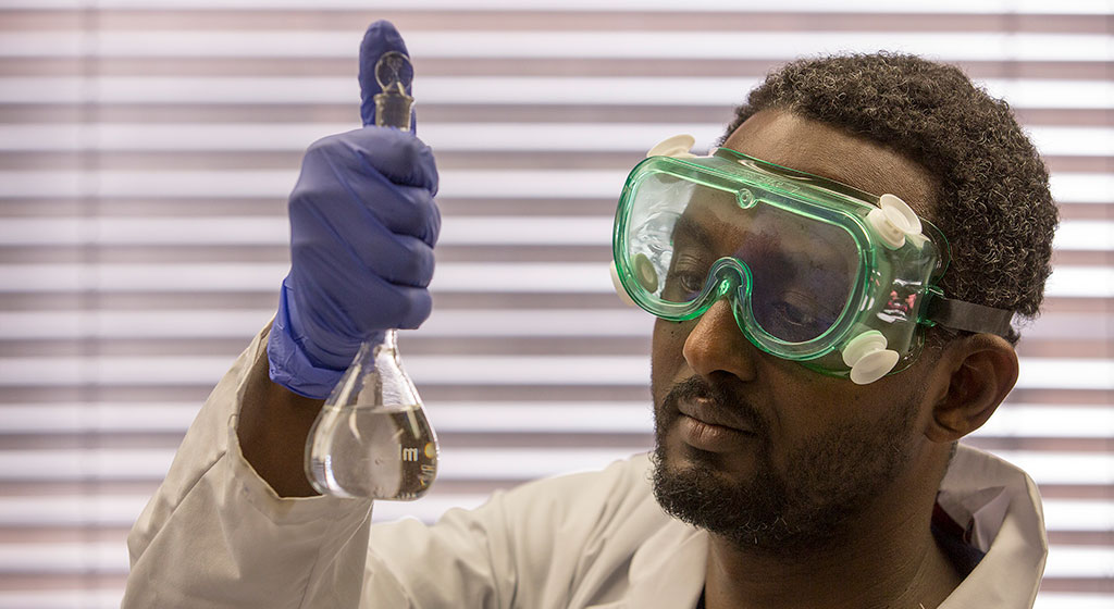 Man Looking at a beaker