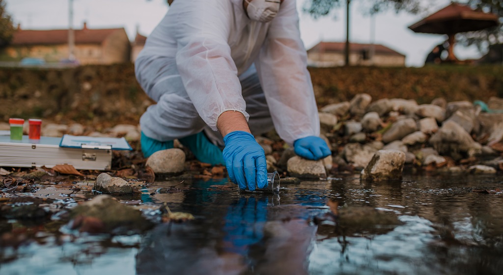 A person collecting a water sample.