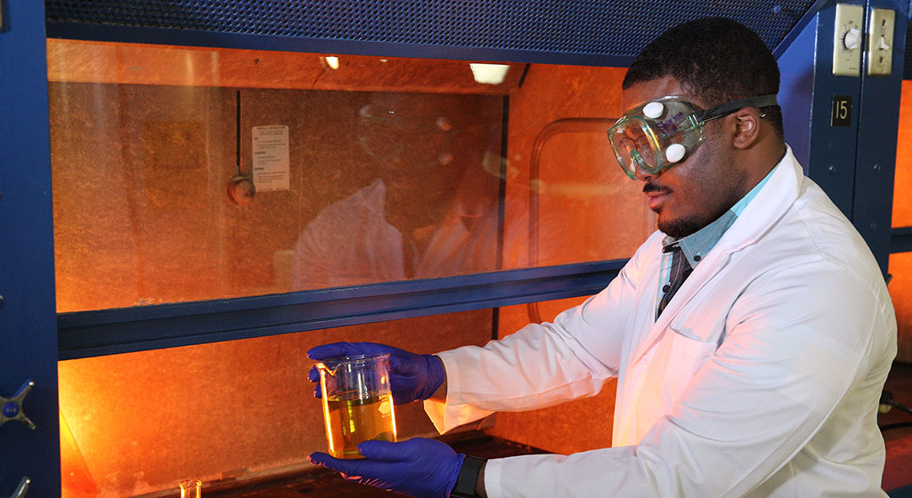 Male lab tech doing an experiment.