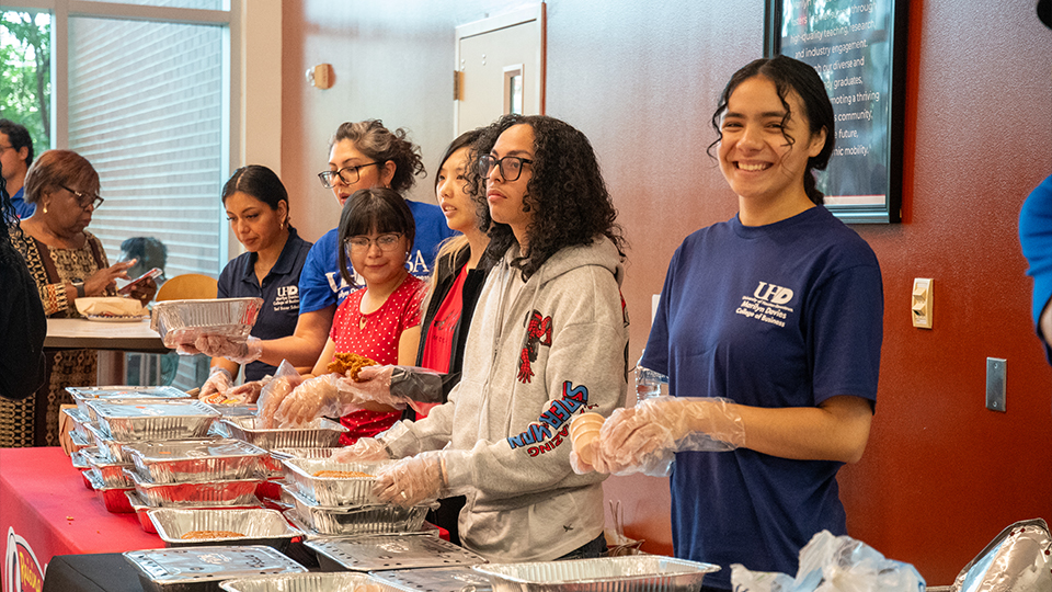 Students serving food in the MDCOB
