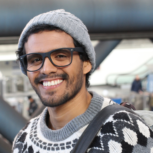 smiling male student outside and dressed warmly