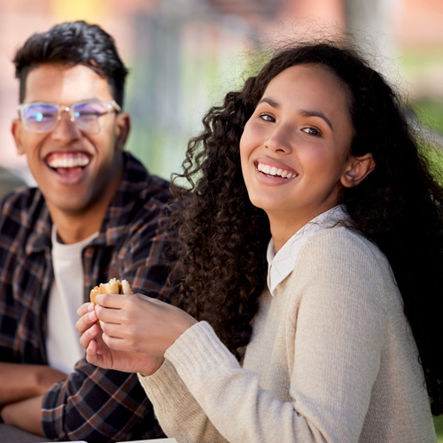 smiling students sitting outdoors