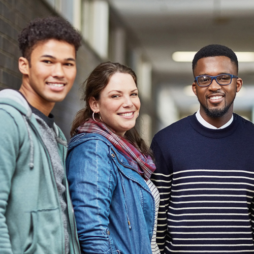 three college students standing in a hallway