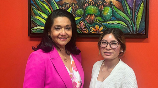 University of Houston Downtown alumna Paula Mendoza stands aside intern and marketing major Jocelynn Sanchez