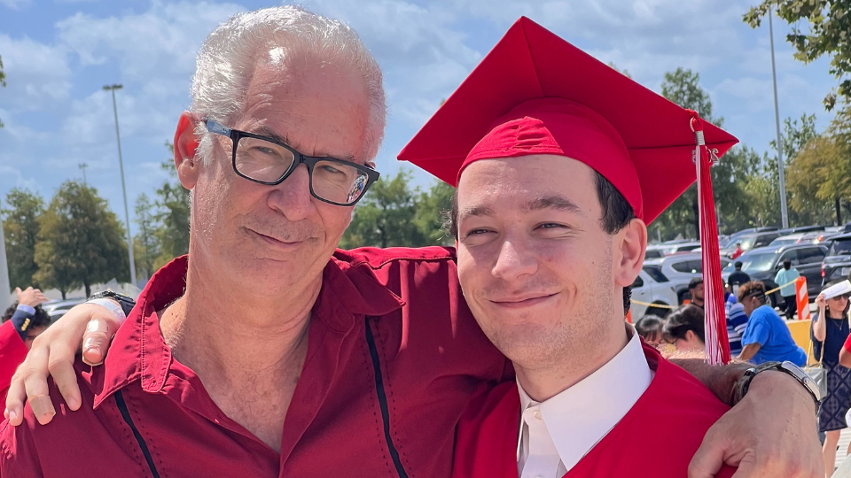 parent and graduate in cap and gown