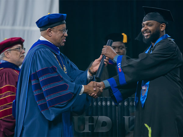 Blanchard handing diploma to student