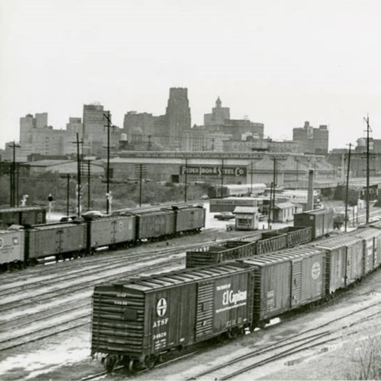 Black and white image of Hardy Railyards with old downtown Houston in the background.