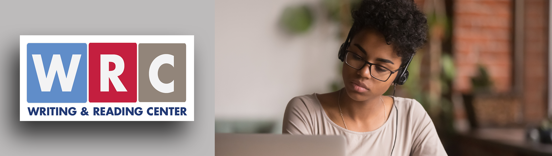 Student studying on laptop with headphones on