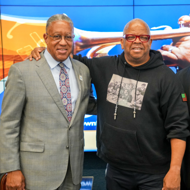 The University of Houston-Downtown President Dr. Loren Blanchard stands aside Terence Blanchard at a 2024 President's Lecture Series. 