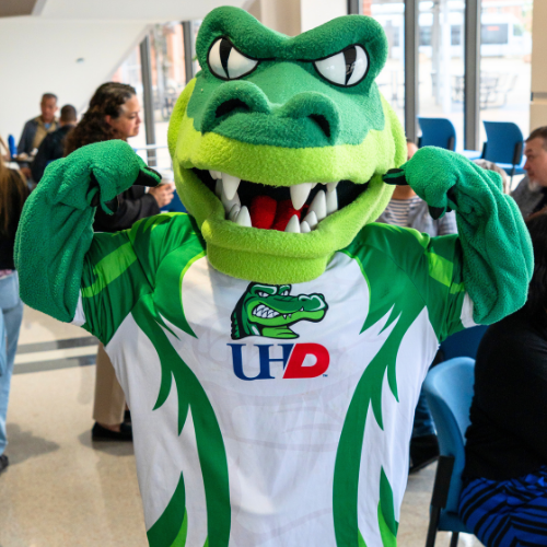 University of Houston-Downtown mascot Ed-U-Gator shows their muscles