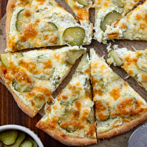A pizza with dill pickles 