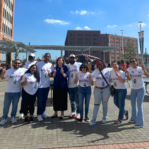 UHD Provost Deborah Bordelon smiles aside students in the undergraduate student government association wear walk2vote t-shirts during the university of houston-downtown's walk2vote event in downtown houston