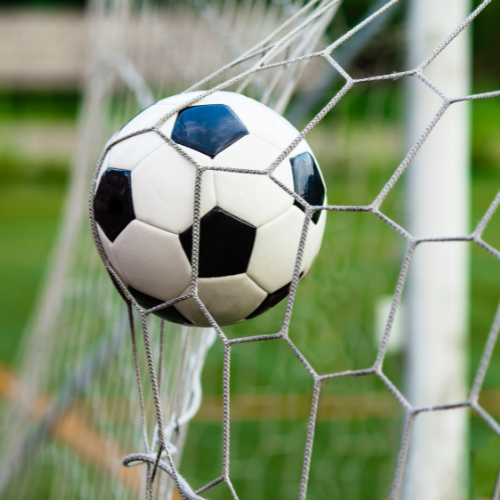A soccer ball hits soccer net