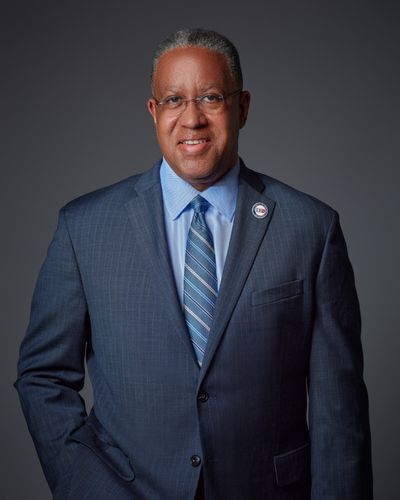 Loren Blanchard President of the University of Houston Downtown smiles in a suit and tie