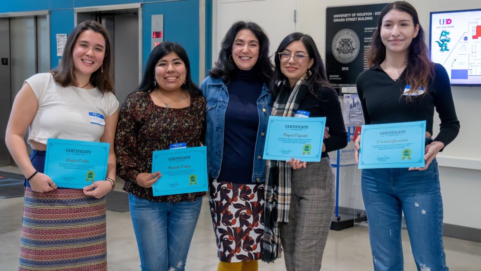 4 women holding certificates