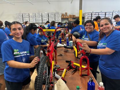 UHD volunteers build a bike.