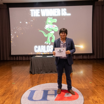 UHD student athlete holds an award certificate at UHD's student awards in downtown houston