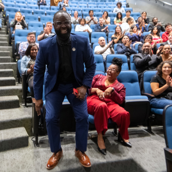 Tremaine Kwasikpui gets up from a seat at his name is called for an award at UHD's One Main Event