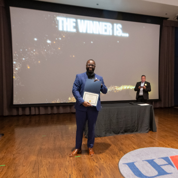 Tremaine Kwasikpui holds an awards certificate at One Main Event 